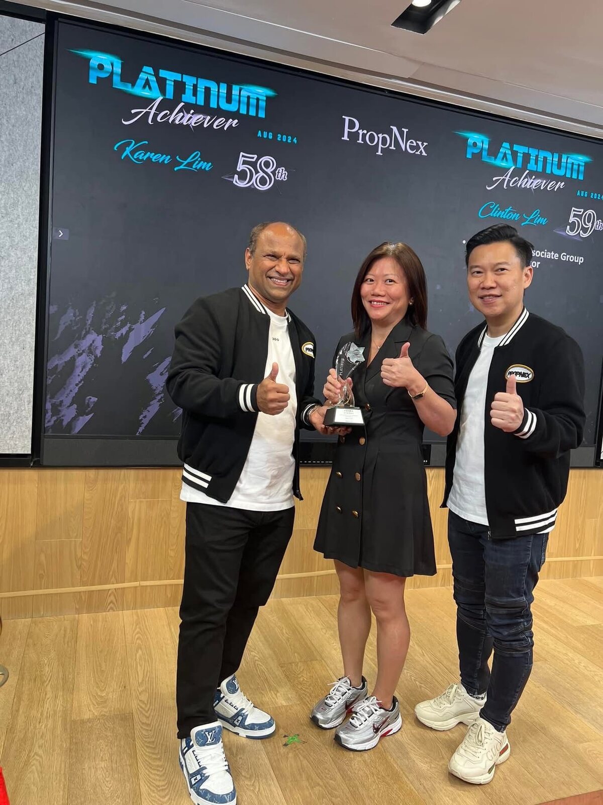 Karen Lim receiving the PropNex Platinum Achiever award for August 2024 on stage