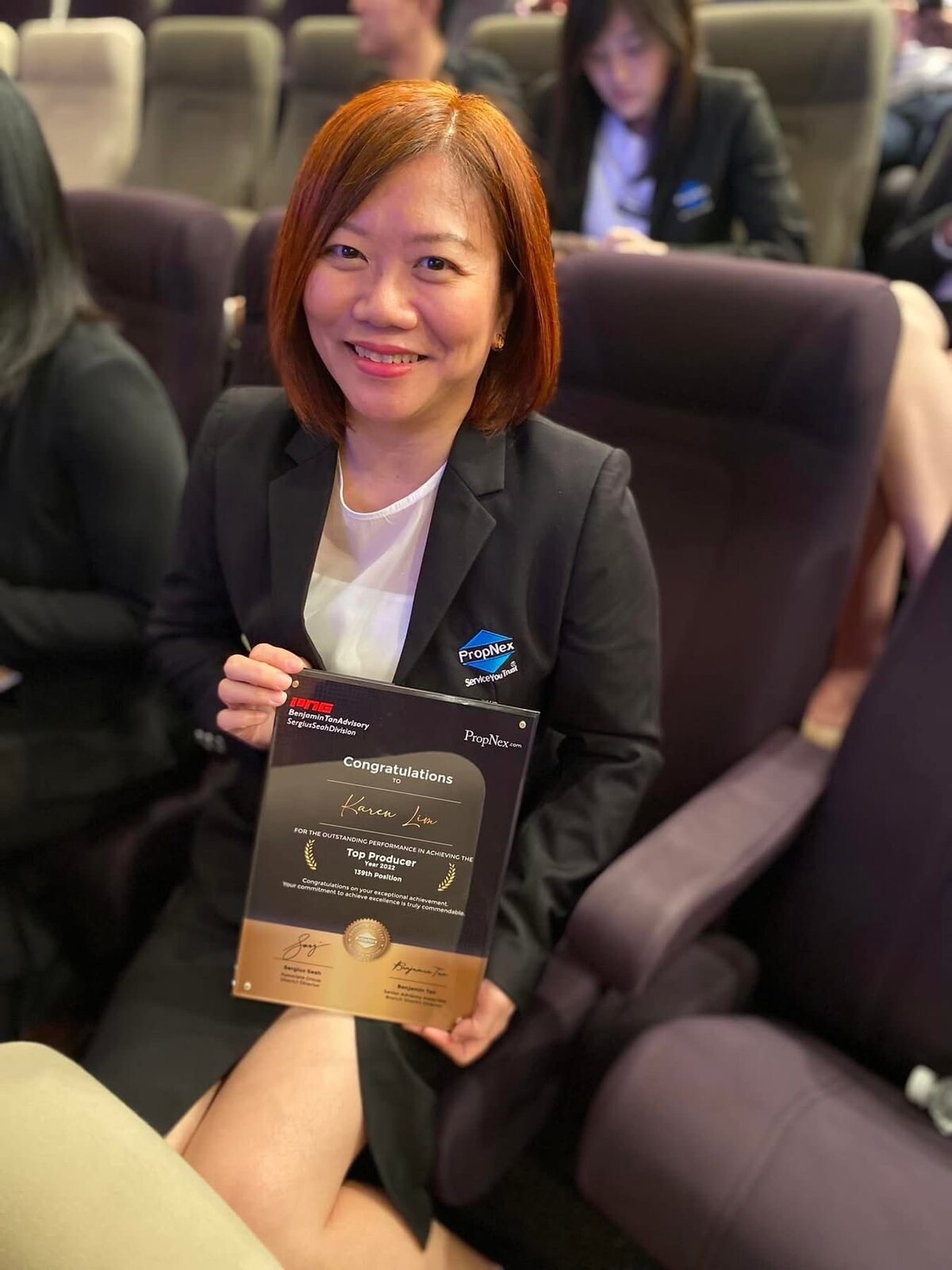 Karen Lim holding her Top Producer Year 2022 plaque