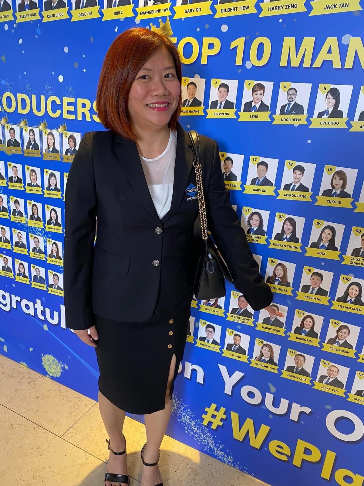 Karen Lim at a PropNex producers recognition wall
