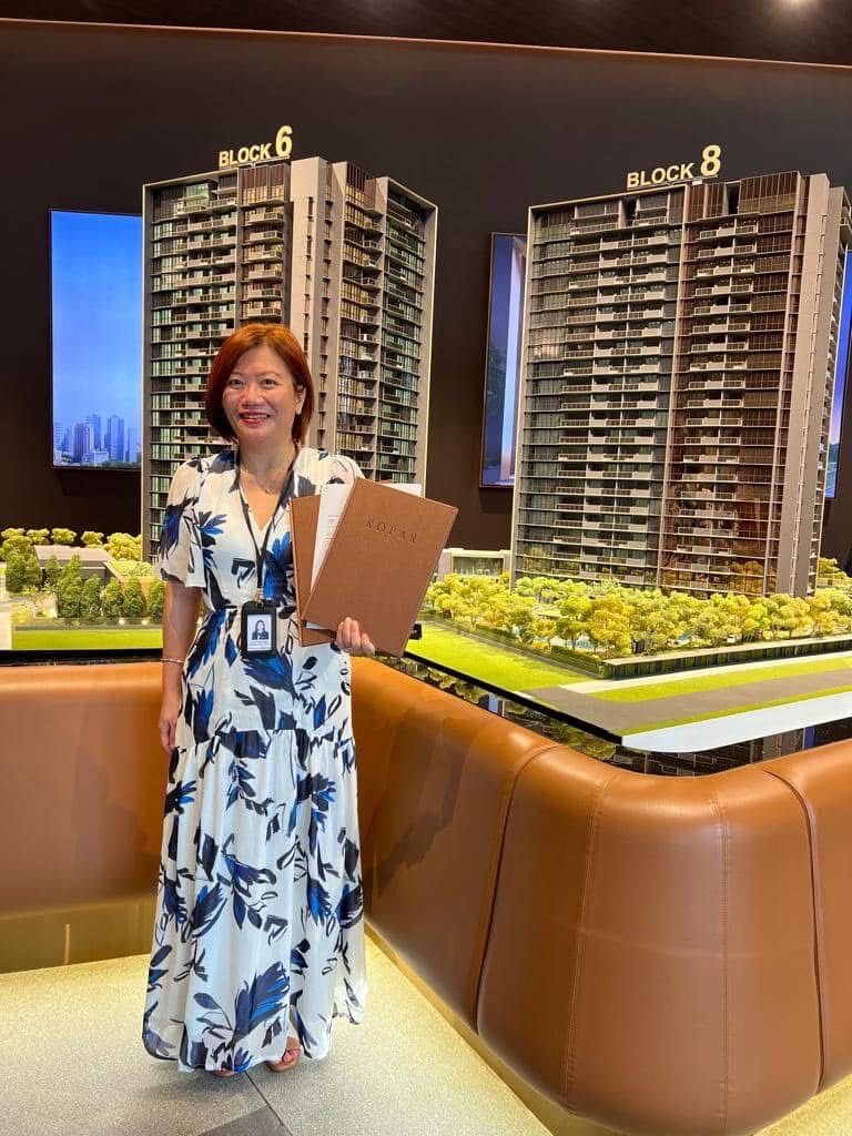 Karen Lim at a Singapore showflat beside the scale model of a new development